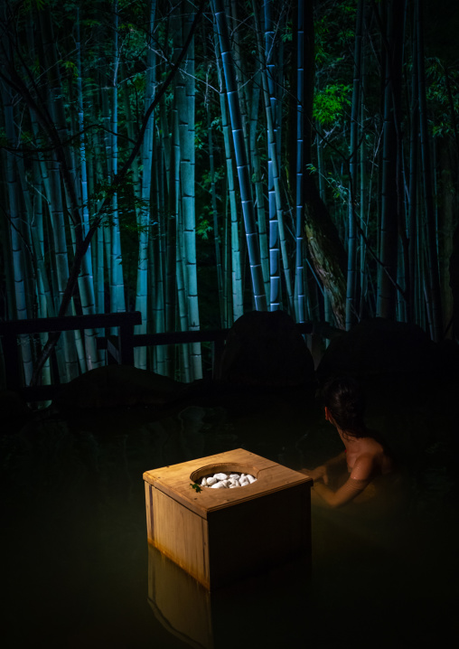 Woman bathing at hot spring next to a bamboo forest in Takefue ryokan, Kumamoto Prefecture, Minamioguni-machi, Japan