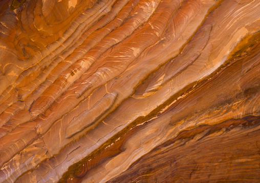 Waves Of Natural Color Drift Through A Sandstone Rock Face In Petra, Jordan