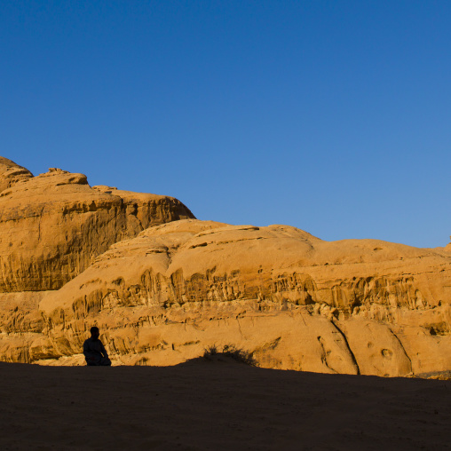 Man Praying In Wadi Rum Desert, Jordan