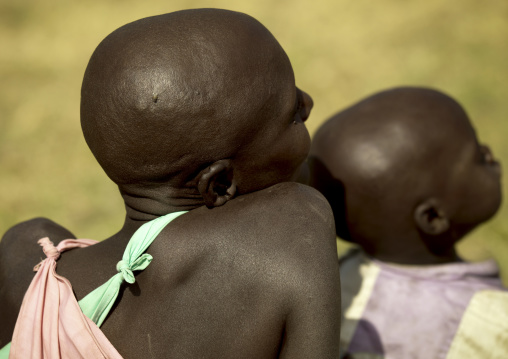 Maasai woman with shaved head and her child, Rift Valley Province, Maasai Mara, Kenya
