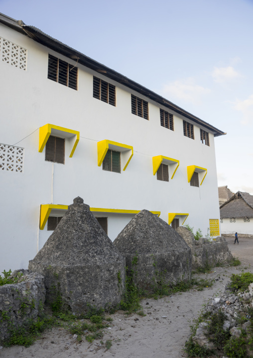 Old muslim graves in front of a modern building, Lamu county, Matondoni, Kenya