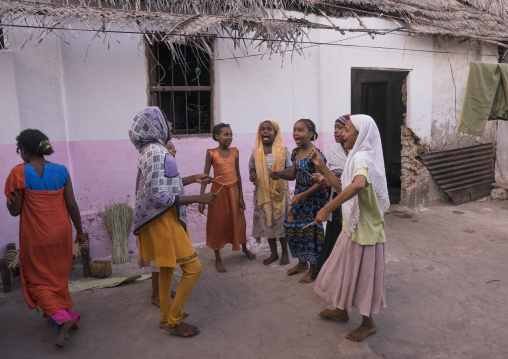 Girls dancing and singing in a courtyard, Lamu county, Matondoni, Kenya