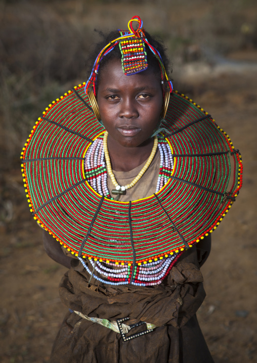 A pokot girl wears large necklaces made from the stems of sedge grass, Baringo county, Baringo, Kenya
