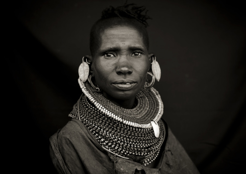Portrait of a Turkana tribe woman with large earrings and necklaces, Rift Valley Province, Turkana lake, Kenya