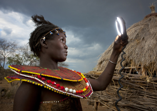 A pokot woman wears large necklaces made from the stems of sedge grass, Baringo county, Baringo, Kenya