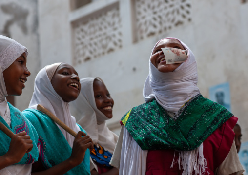 Two young girls singing in traditional suit during maulidi, Lamu County, Lamu, Kenya