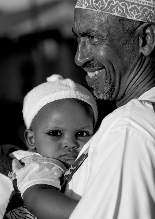 Muslim father with his baby, Lamu County, Lamu, Kenya