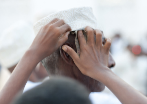 Muslim man with bank notes under his kofia during Maulid festival, Lamu County, Lamu, Kenya