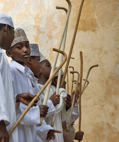Muslim children dancing with sticks during Maulid festival, Lamu county, Lamu, Kenya