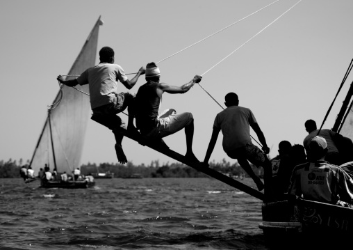 Man balancing dhow while sailing, Lamu County, Lamu, Kenya