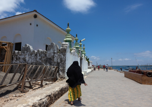 Muslim woman passing in front of a mosque, Lamu County, Lamu, Kenya