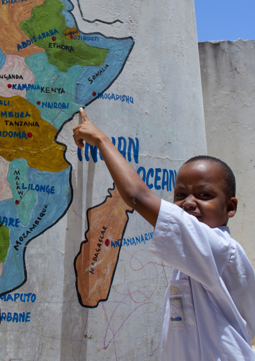 Pupil showing Lamu on painted map at school, Lamu County, Lamu, Kenya