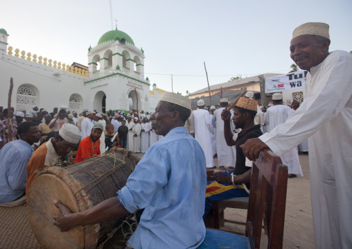 Muslim men singing and dancing with goma sticks during Maulid festival, Lamu County, Lamu, Kenya