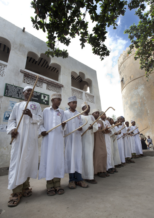 Muslim men singing and dancing with goma sticks during Maulid festival, Lamu County, Lamu, Kenya