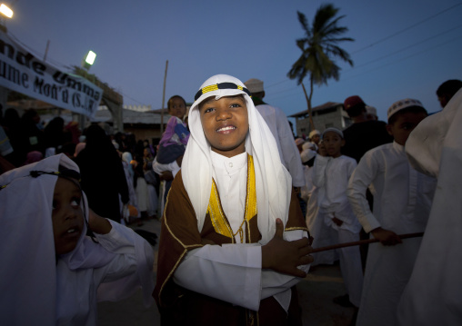 Young boy in traditional clothing among crowd during Maulid festival, Lamu County, Lamu, Kenya
