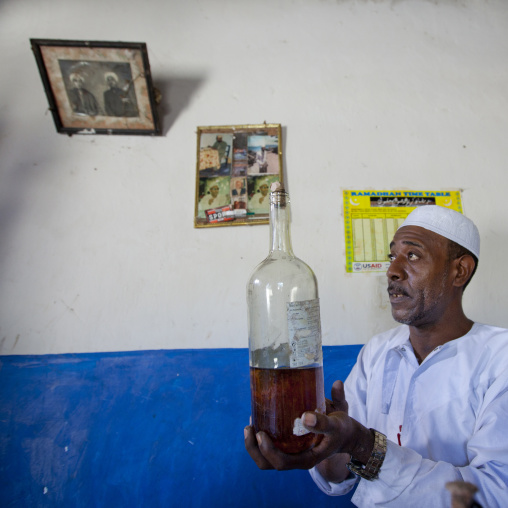 Witch doctor holding a bottle of mysterious potion, Lamu County, Lamu, Kenya
