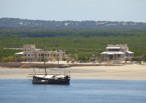 Dhow mooring along the beach in front of luxury villas, Lamu County, Manda island, Kenya