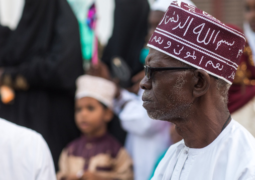 Sunni muslim man with a kofia celebrating the maulidi festivities in the street, Lamu county, Lamu town, Kenya