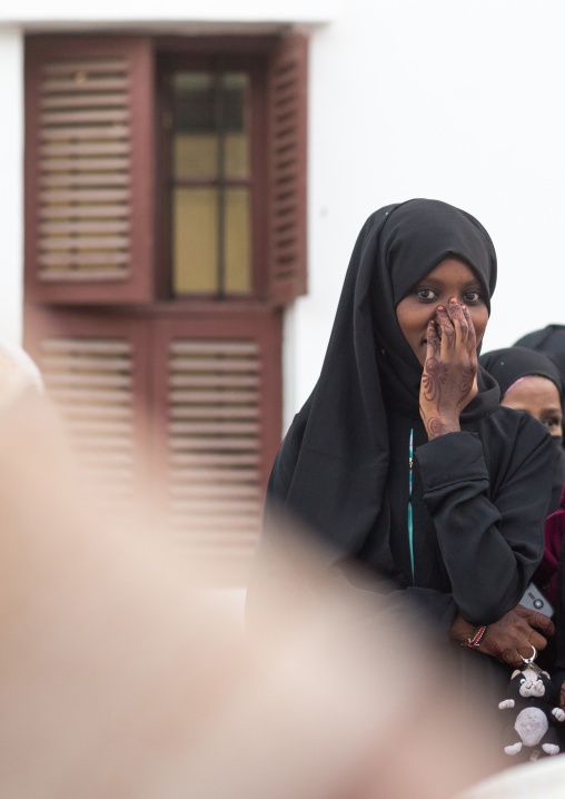 Muslim veiled young woman in the street during maulidi festivities, Lamu county, Lamu town, Kenya