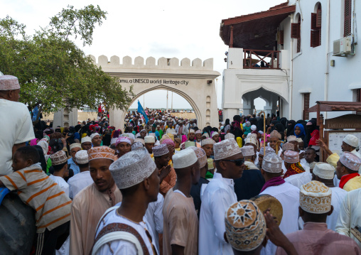 Sunni muslim people parading in front of the town gate during the maulidi festivities in the street, Lamu county, Lamu town, Kenya