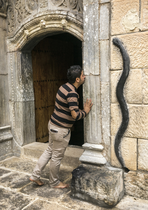 A Man Kisses A Door In The Historic Temple Of Yazidis In The Village Of Lalesh, Kurdistan, Iraq