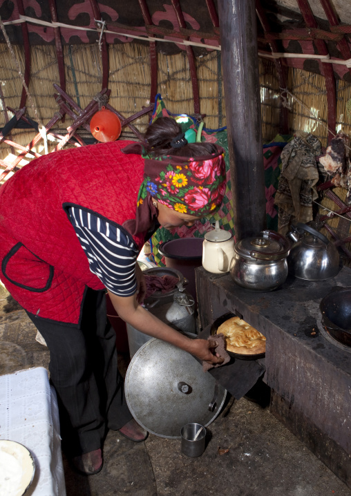 Woman With Headscarf Baking Bread Inside Her Yurt, Song Kol Lake Area, Kyrgyzstan