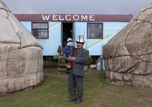 Man With Kalpak Hat Holding His Baby In His Arms, Saralasaz Jailoo, Kyrgyzstan