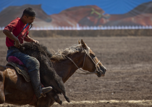 Horseman Carrying A Goat Carcass For A Horse Game On National Day, Bishkek, Kyrgyzstan