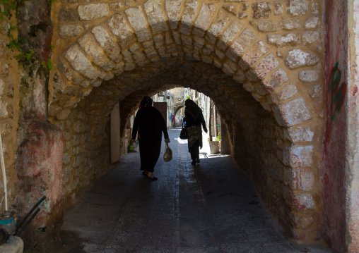 Women passing thru an arch in the old town, South Governorate, Tyre, Lebanon