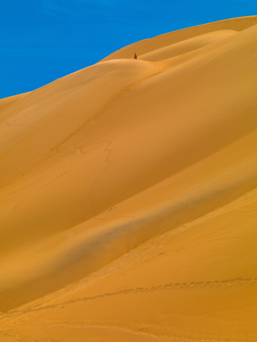 People climbing the dunes in ubari desert, Fezzan, Umm al-Maa, Libya