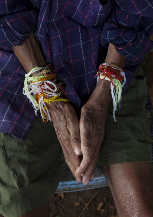Man with baci strings bracelets, Boloven, Laos