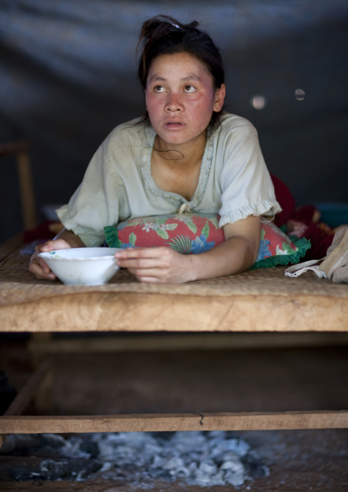 Bru new mother resting above a bed of ashes, Katou, Laos
