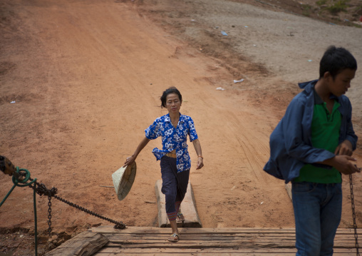 Woman using the ferry on mekong river, Phonsaad, Laos