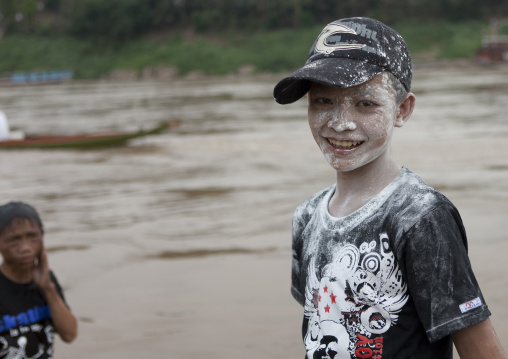 Boy with flour on the face during pii mai lao new year celebration, Luang prabang, Laos