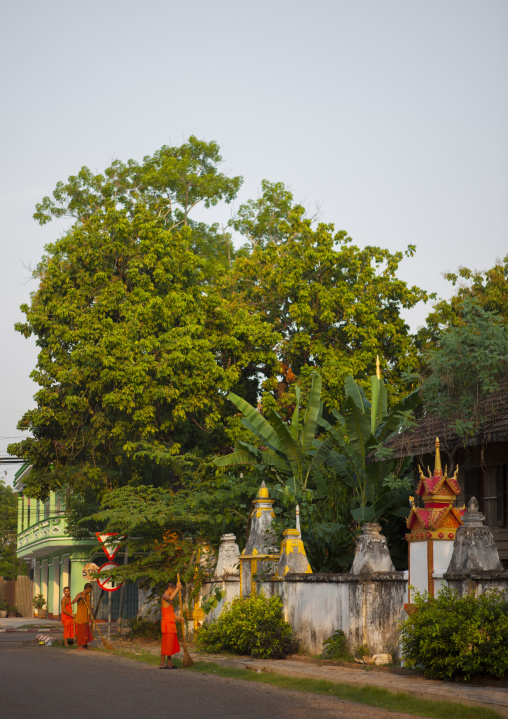 Monks cleaning the street, Savannakhet, Laos