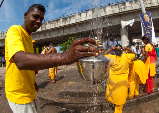 Hindu Pilgrim Collecting Water In A Jar In Annual Thaipusam Religious Festival In Batu Caves, Southeast Asia, Kuala Lumpur, Malaysia