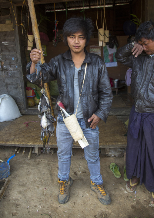 Chin Man Buying Hunted Birds In A Market, Mindat, Myanmar
