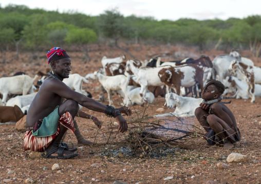 Himba Family In Front Of The Sacred Fire, Epupa, Namibia