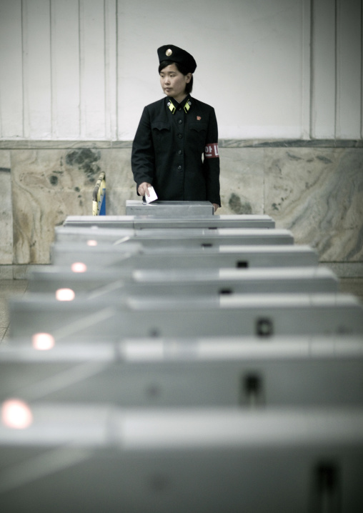 North Korean subway employee in front of a tickets machine, Pyongan Province, Pyongyang, North Korea