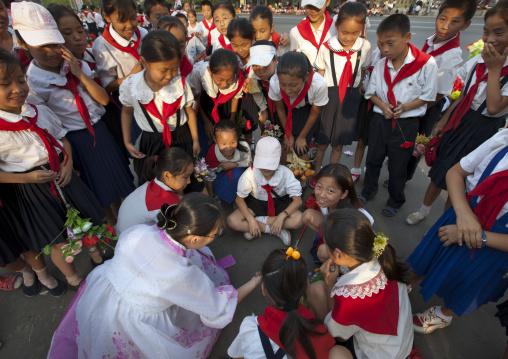 Smiling and laughing group of pioneers children in the street, Pyongan Province, Pyongyang, North Korea