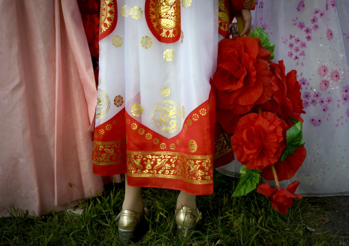 North Korean women in choson-ot with plastic bunches of red flowers, Pyongan Province, Pyongyang, North Korea