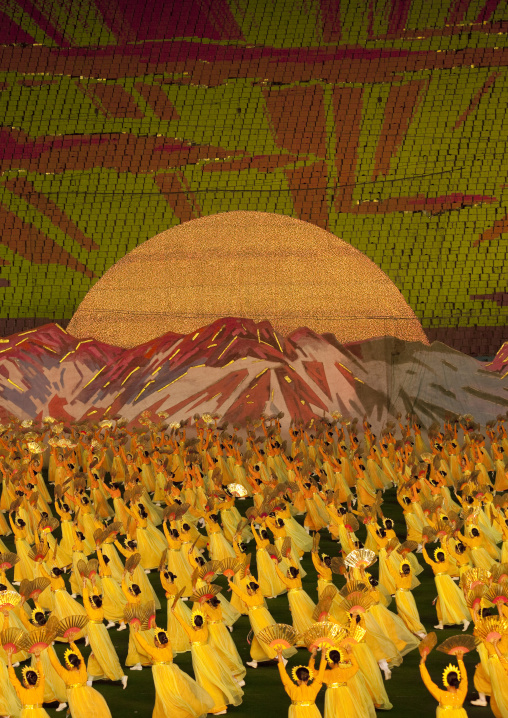 Rising sun over mount Paektu made by children pixels holding up colored boards during Arirang mass games in may day stadium, Pyongan Province, Pyongyang, North Korea
