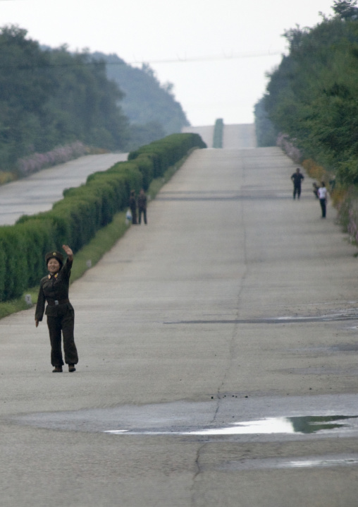 North Korean soldier trying to stop a bus on a highway, North Hwanghae Province, Kaesong, North Korea