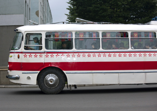 Public bus decorated with red stars one star represents 50000 km of safe driving, Pyongan Province, Pyongyang, North Korea