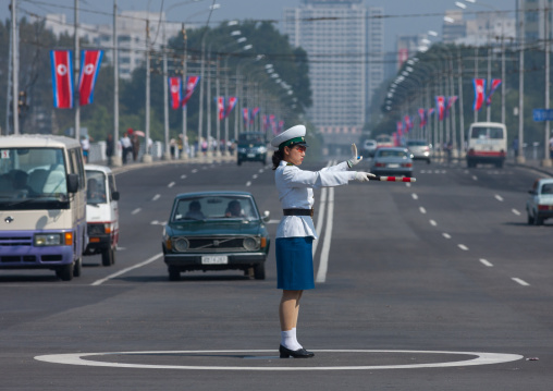 North Korean female traffic security officer in white uniform in the street, Pyongan Province, Pyongyang, North Korea