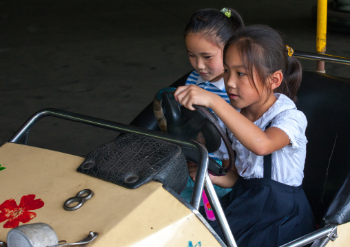 North Korean girls having fun in bumper cars at Taesongsan funfair, Pyongan Province, Pyongyang, North Korea