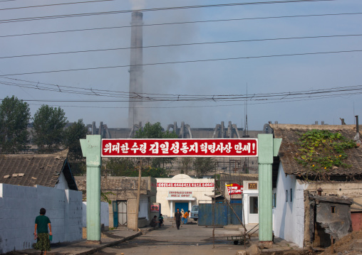 Propaganda slogan on a red billboard at the entrance of a factory saying long live the revolutionnary ideology of great leader Kim Jong-il, Pyongan Province, Pyongyang, North Korea