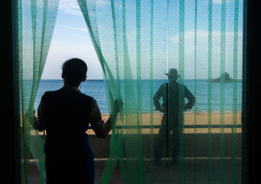 North Korean people on a balcony in front of a beach, North Hamgyong Province, Chilbo Sea, North Korea