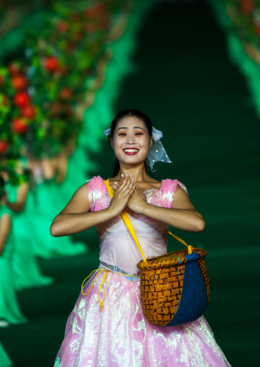 North Korean women dancing between apples during the Arirang mass games in may day stadium, Pyongan Province, Pyongyang, North Korea