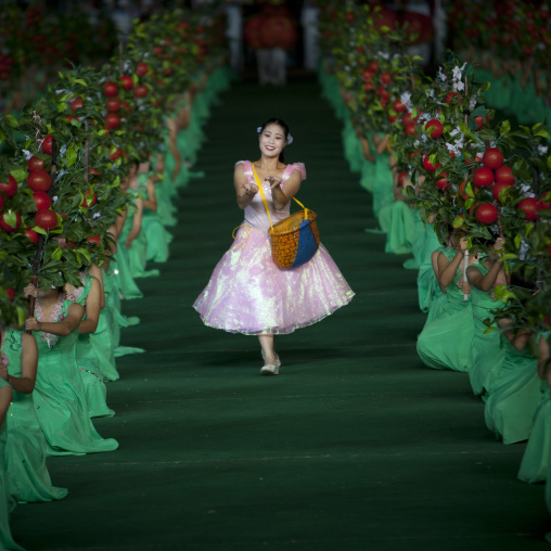 Women dancing between apples at Arirang mass games in may day stadium, Pyongan Province, Pyongyang, North Korea